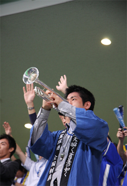 Japanese people use different ways to support their team. They use flags and trumpets to cheer their favorite team.